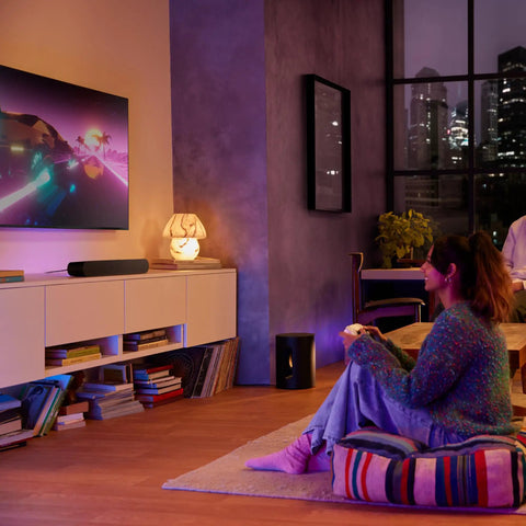 Sub Mini Compact Wireless Subwoofer for Beam and Ray in a stylish living room, enhancing home theater audio with deep bass.