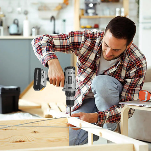 Man using Killer 20V Cordless Drill Set With 2.0 Ah Battery And Charger 30 Nm Torque on wooden furniture assembly.