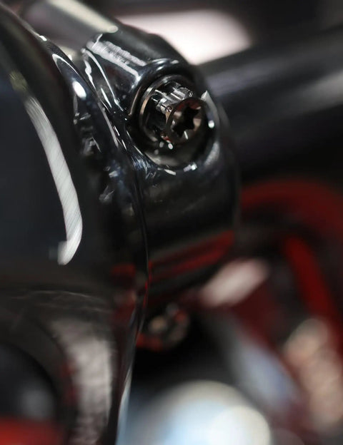 Close-up of Top Shelf Titanium Handlebar Clamp Bolts And Brake Clutch Perch Screws For Heavy Duty Motorcycles on a motorcycle