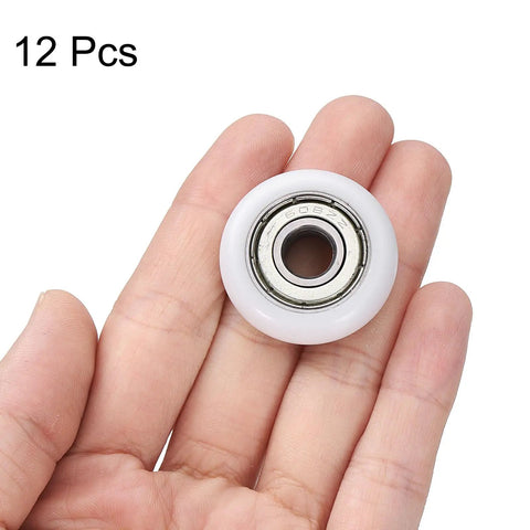 No Sweat Heavy Duty Nylon Ball Bearing Rollers 12 Pack Smooth Operator Idler Pulley Wheel held in hand, showing 608ZZ bearing.