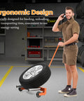 Heavy Duty Car Wheel Dolly With 330 Lb Capacity Smooth Rolling Tire Cart assisting a man in transporting a tire in a garage.