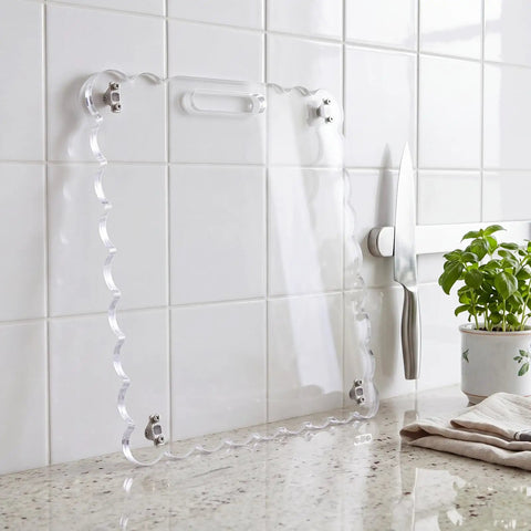 Slick Acrylic Appliance Slider With Swivel Casters And Wavy Scalloped Trim For Easy Kitchen Counter Sliding against white tiles.