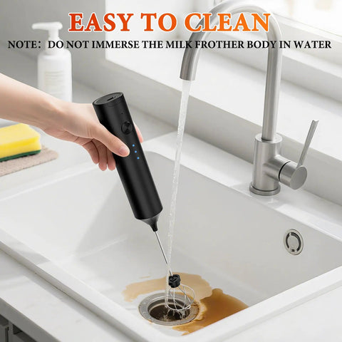 Hand holding a Rechargeable Handheld Milk Frother With 3 Speeds And 3 Stainless Whisks under running tap water.