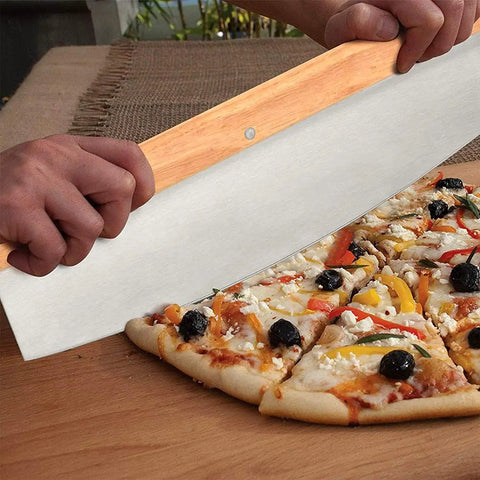 Person cutting pizza with large cutter from 5 Piece Round Pizza Stone Set With 13 Inch Stone, Oak Wood Pizza Peel, 12 By 17 Paddle, Serving Rack