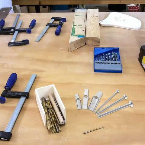 Workbench with assorted tools and 24 Piece Toggle Bolt Kit For Drywall With Wing Nuts And Boxed Set on display