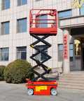 Heavy Duty Scissor Lift Platform For Smooth Station Connection And Quick Material Height Adjustment Transform Your Workshop Workflow While Safely Moving Big Loads With Zero Sweat Now, red scissor lift shown up high near building.