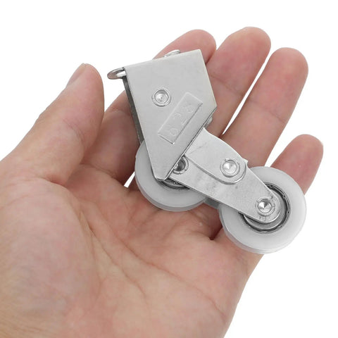 Four Piece Heavy Duty Aluminum Pulley Rollers For Smooth Sliding Doors And Windows Straight Up Quick Swap Garage Track Replacement Hardware held in hand
