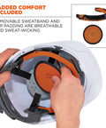 Person adjusting Skullerz 8973LED White vented hard hat with light, full brim style, showing ratchet suspension and removable padding.