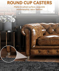 Vintage Round Cup Caster Wheels Set Of Two Silent Rolling Zinc Alloy Floor Casters under a leather sofa with a matte finish.