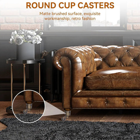 Vintage Round Cup Caster Wheels Set Of Two Silent Rolling Zinc Alloy Floor Casters under a leather sofa with a matte finish.