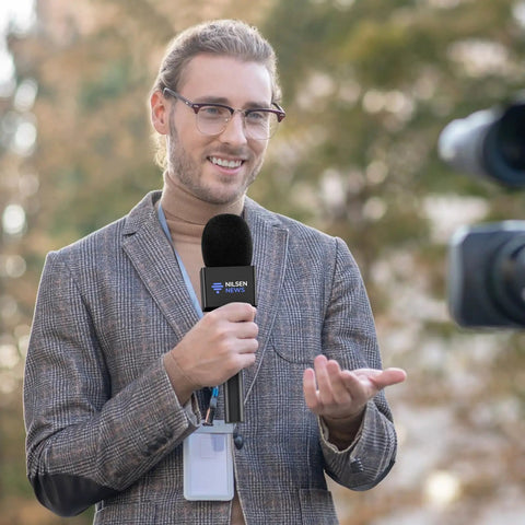 Man using Super Smooth Grip Handheld Adapter For Wireless Lavalier Mics In A Solid Twin Pack Setup Compatible With Dji Rode And Hollyland Gear.