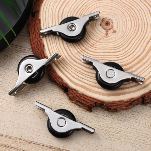 Heavy Duty Sliding Door Rollers Four Pack With Silky Nylon Wheels And Tough Steel Mounts For Closet Tracks displayed on wood.