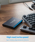 Beefy 4TB Portable SSD USB-C External Solid State Drive Metal Build next to keyboard on wooden desk