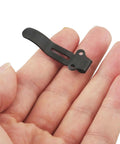 Knifemen Gonna Swear By This Badass 20 Piece Pocket Knife Upgrade Kit featuring a black deep carry clip held in a hand.