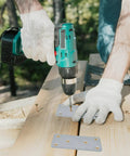 Person using a drill to install Twenty Pack Stainless Steel Flat Mending Brackets for Furniture Repair on wooden planks.