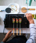 Preparing food with Long 32 Inch Telescoping Marshmallow Roasting Sticks For Fire Pit Smores Skewers Kit on a griddle