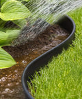 All In One Garden Edging Kit With 200 Ft Flexible 4 Inch Tall Border separating grass and plant area in garden