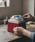 A person using the Sleek Compact Electric Grinding Machine And Polisher Shaper With Vertical Spindle for fine carving on a workbench.