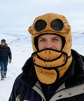 Person wearing Winter Hat With Thermal Barrier And Fleece Lining, Insulated Bonnet With Detachable Eye Shield, in snow, Bold Yellow