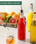 Eight Pack Of 33 Oz Swing Top Glass Bottles With Secure Caps And Lead Free Design Top For Brewing Kombucha And Syrups Includes Funnels Pourers Spare Rings And Waterproof Stickers So You Can Store Your Batch Straight Up No Drama And Keep Your Space, featuring bottles filled with colorful drinks and a pouring action.