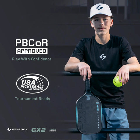 Person holding GX2 Hyper Pickleball Paddle With Aerodynamic Hyper Shape And SST 2.0 Carbon Core next to USA Pickleball Approved sign