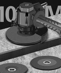 Badass Drill To Angle Grinder Adapter That Swaps Your Standard Hand Drill Into A Heavy Duty Rotary Polisher And Quick Cut Tool For Top Shelf Grind Every Weekend with disc and handle on gray surface.