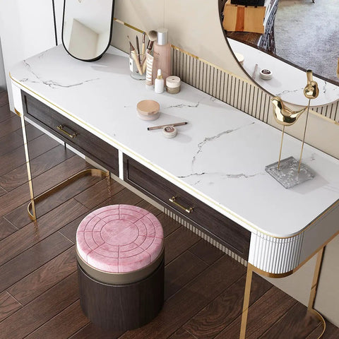 Vanity table with white marble countertop contact paper, featuring a pink stool and cosmetics, on wooden floor.