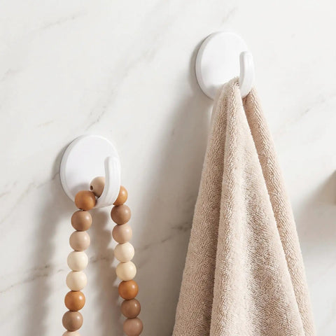 Eight Piece White Peel And Stick Wall Hooks Offer A Super Strong Hold That Skips The Drilling Headaches While Making Everyday Organizing Easy Peasy And Totally Damage Free For Any Room, displaying a towel and beads hanging.