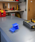 Four Piece Auto Body Dent Puller Kit With Manual Expansion And Portable Plastic Tabs on workshop table