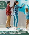 Family painting a wall, using a Rugged Cotton Duck Drop Cloth For Painting And Protection, Washable And Reusable 8x10 Ft Canvas Tarp.