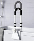 Rock Solid Adjustable Bathtub Safety Rail And Grab Bar Handle With Non Skid Grip For Steady Balance Clamp Install Fits Three To Seven Inch Tub Walls Built Tough To Safely Carry Three Hundred Pounds For Seniors shown mounted on a tub with a gray towel.