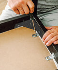 Person installing Beefy 12 Pack Black Triangular Shelf Brackets Made From Cold Rolled Steel For Wood Shelves Heavy Duty Corner Supports
