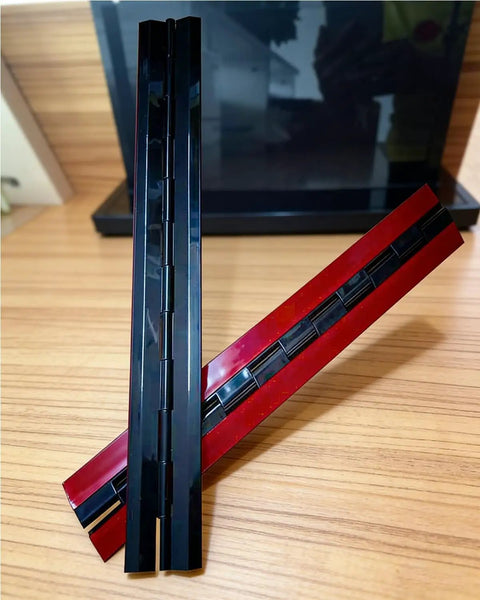 Top Shelf Acrylic Continuous Piano Hinges 12 Inch Black 2 Piece Set For Clear Display Cases Figurine Boxes Model Dust Covers Sweet Fit Zero Hassle Swings displayed on wood surface.