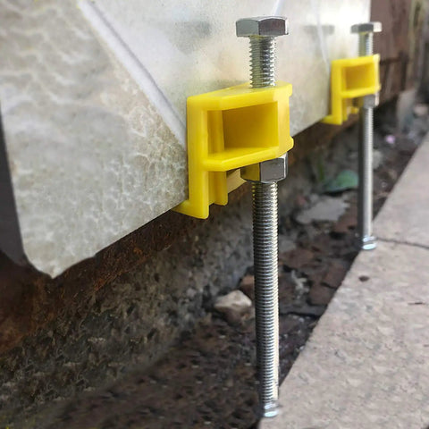 Tile Leveling System Kit With Portable Lifting Tool on wall, showing adjustable height locator and steel rails supporting tiles.