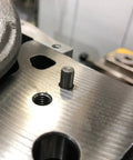 Close-up of 55 Piece 304 Stainless Steel Dowel Pins M3 X 20MM in a metal bracket, showing cylindrical shape for sturdy alignment.
