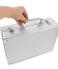 Hand gripping the handle of a Slick Aluminum Alloy Toolcase Featuring Custom Foam Padding, compact travel rig for power tools.