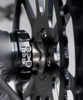 Heavy Duty Steel Wave Washers Five Piece Set For Bike Bottom Bracket Crank Stabilizer rust proof washers close-up with black hub.