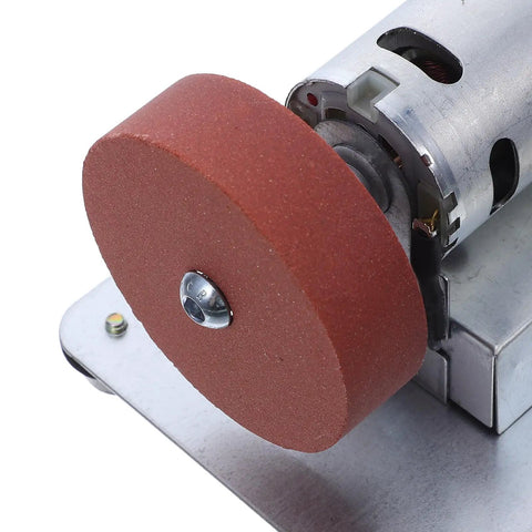 Close-up of Knockout Bench Top Electric Grinding Machine with Rock Solid Anti Slip Base, featuring grinding wheel for metal polishing.