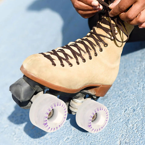 Person tying laces on roller skate with Two Pack LED Light Up Quad Roller Skate Wheels With Bearings For Indoor And Outdoor Skating
