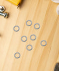 M6 Spring Lock Washers Heavy Duty Stainless Steel 300 Piece Pack arranged on wood surface for workshop repairs and upgrades.