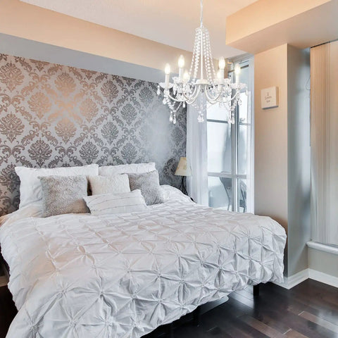 Six Light White Crystal Candle Chandelier For Dining Room And Living Spaces Modern Farmhouse Glam Fixture With Clear Pendant Ornaments Prewired And Easy Install Perfect For Entryway And Foyer hanging in a bedroom.