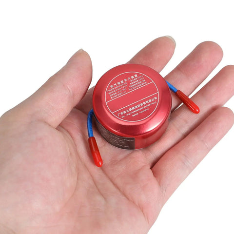 Self Activating Aerosol Fire Extinguisher For Car Engines And Boats With Instant Heat Trigger, held in hand for size reference.