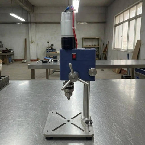 Compact Miniature Desktop Drill Press With Stable Footprint Base on a metal workbench, featuring a steel frame and precise drill head.