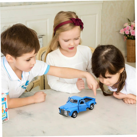 Children playing with Little Blue Truck Pull Back Toy Car With Opening Door on a table, showing retro style and alloy build.