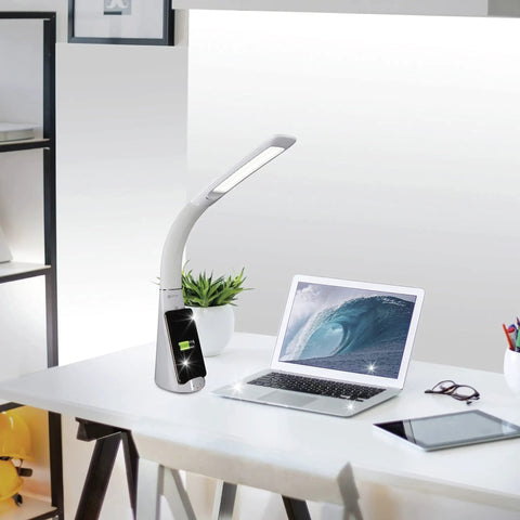 Purify LED Desk Lamp with Wireless Charging on an office desk, featuring touch activation and flexible gooseneck, next to a laptop.