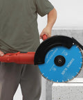 Heavy Hitter Circular Concrete Saw Powered By A Rugged 3000W Copper Motor And Thirteen Point Eight Inch Blade cutting through concrete.