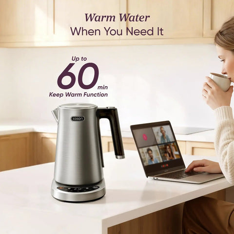 Fast Boiling 1.7L Electric Kettle With Plastic Free Interior And 5 Presets For Tea And Coffee on kitchen counter with laptop.