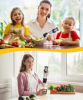 Woman and children using a Six In One Immersion Blender With 1000W Motor And 12 Speed Settings to prepare a salad.