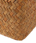 Close-up of natural woven texture of a Spacious Open Top Seagrass Woven Storage Basket With Heavy Duty Handles For Kitchen Farmhouse Pantry Bathroom Towels Cosmetics And Hassle Free Daily Organization Goals.