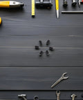 50 Piece M4x6 Stainless Steel Hex Ball Plunger Set Screws Tough As Nails Heavy Duty Fasteners arranged with tools on a dark wooden surface.